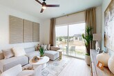 Located in Elkhorn, Nebraska, this thoughtfully designed one-bedroom, one-bathroom home maximizes every inch of its single-floor layout with a clean, modern aesthetic throughout. Light wood-tone flooring flows seamlessly across all rooms, unifying the open-concept living space with a bright, airy feel.

The combined kitchen and living area forms the heart of the home. The kitchen features two-toned cabinetry — white upper cabinets and gray lower cabinets — paired with light quartz countertops, stainless steel appliances including a refrigerator, range, microwave, and dishwasher, and a window above the sink that brings in natural light. A cozy dining nook with a round table sits adjacent to the kitchen.

The living room is anchored by a large sliding glass door that fills the space with natural light and offers views of the surrounding neighborhood. A ceiling fan adds comfort, and the neutral palette creates a calm, welcoming atmosphere.

The bedroom is a serene retreat with windows allowing ample natural light, a ceiling fan, and access to a dedicated closet. The bathroom is well-appointed with gray shaker-style cabinetry, a white quartz vanity, a sliding glass shower-tub combination, light wood flooring, and a small window for ventilation. The overall design is cohesive, modern, and efficiently functional.