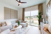 Located in Elkhorn, Nebraska, this thoughtfully designed one-bedroom, one-bathroom home maximizes every inch of its single-floor layout with a clean, modern aesthetic throughout. Light wood-tone flooring flows seamlessly across all rooms, unifying the open-concept living space with a bright, airy feel.

The combined kitchen and living area forms the heart of the home. The kitchen features two-toned cabinetry — white upper cabinets and gray lower cabinets — paired with light quartz countertops, stainless steel appliances including a refrigerator, range, microwave, and dishwasher, and a window above the sink that brings in natural light. A cozy dining nook with a round table sits adjacent to the kitchen.

The living room is anchored by a large sliding glass door that fills the space with natural light and offers views of the surrounding neighborhood. A ceiling fan adds comfort, and the neutral palette creates a calm, welcoming atmosphere.

The bedroom is a serene retreat with windows allowing ample natural light, a ceiling fan, and access to a dedicated closet. The bathroom is well-appointed with gray shaker-style cabinetry, a white quartz vanity, a sliding glass shower-tub combination, light wood flooring, and a small window for ventilation. The overall design is cohesive, modern, and efficiently functional.