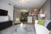 Located in Franklin, TN, this single-floor residence offers a thoughtfully designed layout with a range of functional and comfortable spaces. The kitchen is equipped with light wood cabinetry, generous counter space, wood-look plank flooring, and white appliances including a dishwasher, electric range, and refrigerator — providing everything needed for everyday cooking. The living room features crown molding, a ceiling fan, and sliding glass doors that open to an outdoor patio, allowing ample natural light and views of the surrounding greenery. A dedicated dining area with a pendant light fixture and crown molding provides a defined space for meals. Two bedrooms are present, each with ceiling fans, plush carpet, and walk-in closet access. The primary bedroom offers a serene, restful atmosphere with generous proportions. Two full bathrooms serve the residence — one with a wood-tone vanity, bright vanity lighting, and a tub/shower combination, and a second with clean white fixtures and a tub/shower combo. A dedicated laundry area houses a full-size side-by-side washer and dryer with overhead shelving. Throughout the home, neutral tones, wood-look flooring, and consistent finishes create a cohesive and inviting atmosphere.