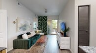 Located at 2157 E Apache Blvd in Tempe, Arizona, this single-floor apartment offers 680 square feet of thoughtfully designed living space across three bedrooms and three bathrooms. The unit features a modern aesthetic throughout, with light wood-look flooring connecting the main living areas and neutral gray-toned walls creating a clean, cohesive palette.

The kitchen is appointed with granite countertops, two-tone cabinetry pairing dark lower cabinets with white uppers, a tile backsplash, and a full suite of stainless steel appliances including a range, microwave, dishwasher, and refrigerator. A peninsula with pendant lighting provides additional prep and casual dining space.

Each bedroom features carpeted flooring and windows that allow natural light, with the primary bedroom measuring approximately 110 square feet. Closets include built-in shelving and hanging rods for organized storage. The bathrooms are consistently finished with dark vanity cabinets, white countertops, wood-look flooring, and tub-shower combinations clad in stacked rectangular tile. A hallway nook with granite-topped cabinetry adds functional storage between rooms. Recessed lighting throughout the unit provides consistent illumination across all spaces.
