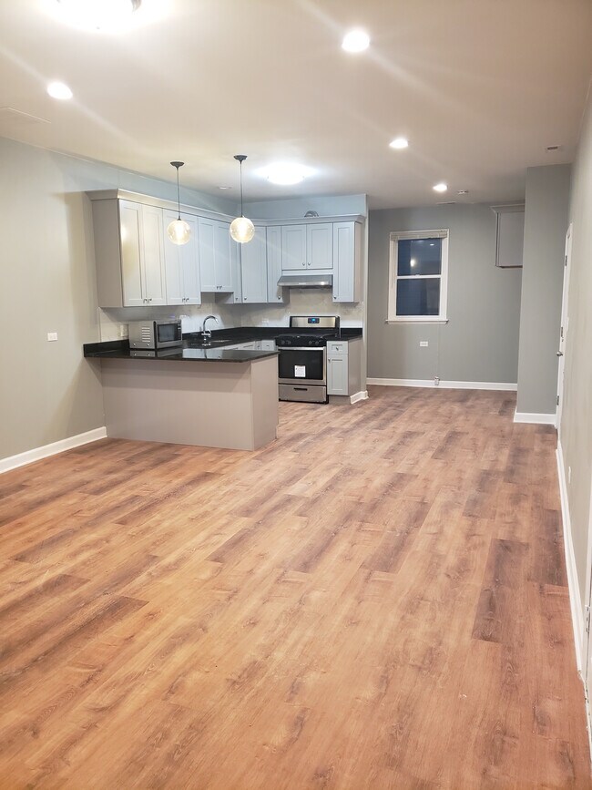 Open concept apartment with large living room, dining, and kitchen - 2892 S Archer Ave