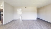 Located at 8610 Pine Tree Ct in Tampa, FL, this 2-bedroom, 1-bathroom unit offers a practical and well-organized single-floor layout. The open living and dining area is finished with light wood-look flooring and neutral walls, with a sliding glass door fitted with vertical blinds that allows natural light to pour in. A second window further brightens the space, creating an airy atmosphere throughout.

The galley-style kitchen features dark espresso cabinetry, granite-look countertops, a double sink, and light tile flooring. It is equipped with a full-size refrigerator and additional appliances, offering efficient use of the space.

Both bedrooms are carpeted and finished in soft, neutral tones. The primary bedroom is generously sized and includes a wide double closet with bifold louvered doors, providing substantial storage. The second bedroom is cozy and well-lit by a window, also with a built-in closet.

The bathroom includes a full tub-shower combo, a granite-top vanity with dark cabinetry, tile flooring, and clean white walls. A hallway connects the main living areas to the bedrooms and bathroom, with an additional closet for extra storage. The overall design is clean, functional, and move-in ready.