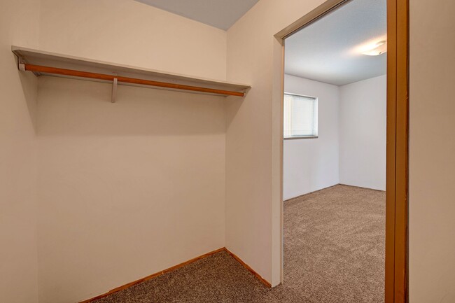 A large walk in closet with shelving - Willow View