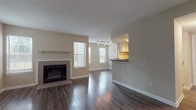 Located in Atlanta, GA (30306), this single-floor residence offers a well-considered layout designed for comfortable everyday living. The open-concept living and dining area serves as the heart of the home, showcasing rich, dark hardwood-style flooring throughout and a classic tile-surround fireplace with a clean white mantel as its focal point. Multiple windows flood the space with natural light, creating an airy and welcoming atmosphere. Track lighting overhead further enhances the brightness of the living area.

The kitchen connects seamlessly to the living space via a pass-through breakfast bar, providing both visual openness and practical functionality. It features white cabinetry with ample storage, dark countertops, a corner sink, and a full suite of appliances including a dishwasher and range.

A hallway leads to two generously sized bedrooms, each finished with plush wall-to-wall carpeting, large windows, and neutral walls. One bedroom includes a ceiling fan with light fixture. The residence features two full bathrooms, each outfitted with white vanity cabinetry, dark hardwood-style flooring, and a shower-tub combination, with one bathroom benefiting from a natural light window. The consistent neutral color palette and quality finishes throughout lend the space a clean, move-in-ready appeal.