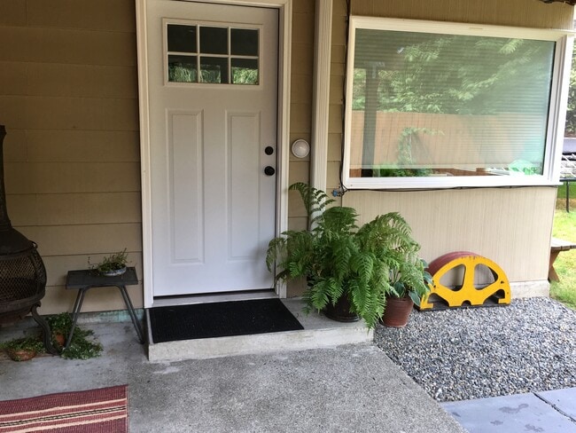 Second photo of front door and patio. Private, front entrance of apartment. Picture before paint job - 3518 Northeast 94th Street