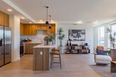 Located at 1350 S Bascom Ave in San Jose, CA, this modern single-floor residence offers four bedrooms and two bathrooms within a thoughtfully designed open-concept layout. The combined kitchen and living area serves as the heart of the home, featuring light hardwood-style flooring, recessed lighting, and large windows that flood the space with natural light. The kitchen is outfitted with warm wood cabinetry, stainless steel appliances, a central island with a white quartz countertop, and pendant lighting — ideal for both meal preparation and casual dining. The living area flows seamlessly from the kitchen and opens to a balcony enclosed by a glass railing, offering open views of the surrounding San Jose streetscape. The primary bedroom provides a comfortable retreat with ample space for a queen or king bed. The two bathrooms feature tile-surround soaking tubs and showers, wood-toned vanities, and white countertops. A dedicated closet with built-in wire shelving systems offers organized storage. Throughout, the design maintains a cohesive contemporary aesthetic with clean lines, neutral tones, and modern fixtures, creating a functional and stylish living environment in the heart of San Jose.