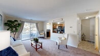 Located at 13901 Echo Park Cir in Burnsville, MN, this two-story, two-bedroom, two-bathroom home offers a practical and comfortable layout spread across two floors. The main level features a welcoming living room with plush carpeting, a sliding glass door opening to an outdoor balcony, and a pass-through opening to the kitchen — creating an open, connected feel. The kitchen is well-appointed with warm oak cabinetry, granite-style countertops, a mosaic tile backsplash, black appliances including a range, microwave, and refrigerator, and tile flooring. Hallways connecting the main living areas are accented with neutral tones and decorative touches. A staircase leads to the upper level, where both carpeted bedrooms offer comfortable retreats filled with natural light from well-placed windows. The primary bedroom provides a generous amount of space, while the second bedroom includes sliding closet doors for convenient storage. Both bathrooms are clean and functional, with one featuring a full soaking tub and shower combination. Textured ceilings, neutral wall tones, and carpet throughout the upper level contribute to a cohesive and cozy ambiance across the entire home.