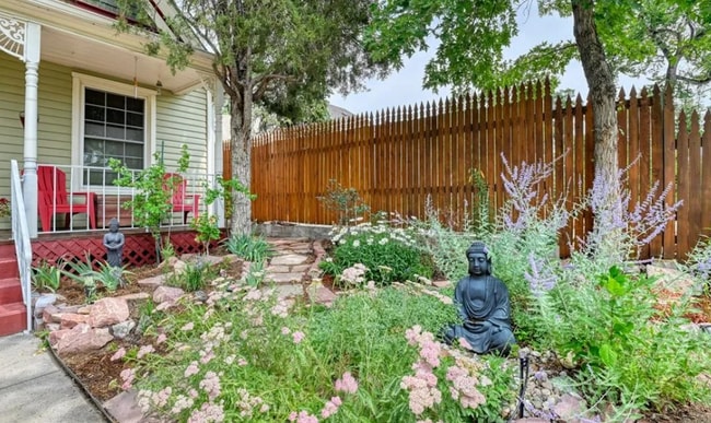 Front garden oasis including raised beds and greenhouse options for gardeners. - 812 E Cache La Poudre St