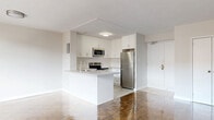 Located at 2303 Eglinton Ave E in Toronto, this well-appointed 2-bedroom, 1-bathroom unit offers a functional and comfortable layout across a single floor. The open-concept kitchen and living area forms the heart of the home, showcasing gleaming polished parquet wood flooring that extends throughout the space. The kitchen features crisp white cabinetry reaching to the ceiling, a granite-topped peninsula with an undermount sink, and a full suite of stainless steel appliances including a refrigerator, electric range, built-in dishwasher, and microwave. Large sliding glass doors in the living area flood the space with natural light and provide direct access to a private balcony with outdoor views. Both bedrooms continue the warm parquet flooring and are served by generous windows with baseboard heating below, ensuring comfort year-round. The primary bedroom includes a double-door closet, while the unit benefits from three closets in total for ample storage. The bathroom is finished with white subway tile in the tub-shower surround, a granite-topped vanity with white cabinetry, and clean tile flooring, maintaining the unit's cohesive, modern aesthetic throughout.