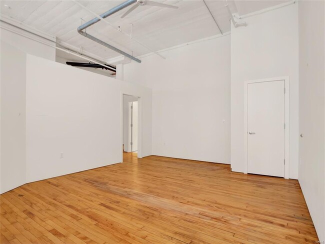 Guest Bedroom With High Ceilings & Original Warehouse Floors - 1010 Saint Charles St