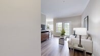 This 800 square foot apartment in Hermitage, Nashville, offers a thoughtfully designed living space with two bedrooms and two bathrooms. The open-concept floor plan combines the kitchen, dining, and living areas, creating a seamless flow for daily activities and entertaining. The kitchen boasts dark wood cabinetry, granite countertops, and black appliances, providing both style and functionality.

The primary bedroom, measuring 180 square feet, features a large closet and ample natural light. Both bedrooms are equipped with comfortable furnishings and neutral color schemes, promoting a restful atmosphere. The bathrooms are clean and modern, with one featuring a bathtub for added convenience.

Throughout the apartment, wood-look flooring adds warmth and durability. Large windows with white blinds allow for plenty of natural light while offering privacy when needed. The living room opens to a small balcony or patio, extending the living space outdoors.

Additional amenities include an in-unit laundry room with full-sized washer and dryer, ensuring convenience for residents. The overall design aesthetic combines contemporary elements with a neutral color palette, creating a versatile canvas for personal style. This apartment offers a comfortable and efficient living solution in a prime Nashville location.