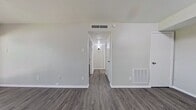 This 530 square foot apartment in Dallas, TX offers a well-designed living space with modern amenities. The single-floor layout comprises one bedroom, one bathroom, a kitchen, a living room, and a hallway, making efficient use of the available space.

The 140 square foot primary bedroom features a large window allowing ample natural light and views of the surrounding area. The room is finished with neutral-toned walls and durable grey wood-look flooring, creating a serene atmosphere.

The bathroom is equipped with essential fixtures including a toilet, bathtub with shower, and a vanity. White tilework in the shower area and on the floor maintains a clean, bright appearance.

The kitchen, while compact, is functional with white cabinetry, light-colored countertops, and full-sized appliances including a refrigerator. The living room is spacious enough to accommodate seating and features French doors leading to an outdoor space, enhancing the sense of openness.

Throughout the apartment, the grey wood-look flooring provides a modern, cohesive look, while white walls and trim create a bright, airy feel. Recessed lighting in the living areas and hallway ensures good illumination throughout the space.

This apartment offers a practical and contemporary living solution, ideal for individuals or couples seeking a low-maintenance urban dwelling in Dallas.