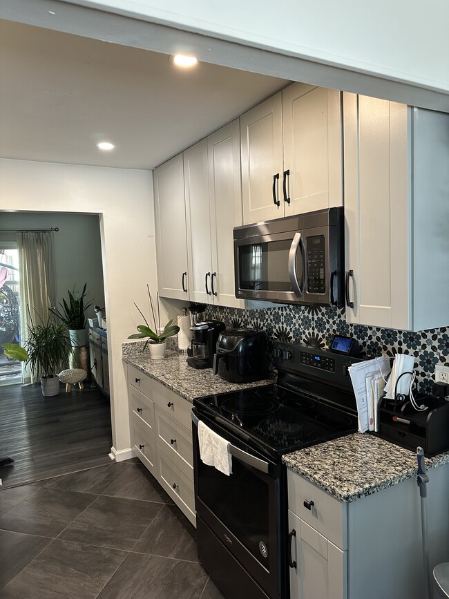 Kitchen area with updated appliances and modern finishes - 3613 Harbinger Rd