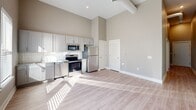 Located at 3440 Southern Ave in Memphis, TN, this one-bedroom, one-bathroom unit offers a thoughtfully designed single-floor layout that maximizes functionality. The open-concept kitchen and living area serves as the heart of the home, featuring stainless steel appliances — including a range, microwave, and refrigerator — paired with gray shaker-style cabinetry, a white subway tile backsplash, and impressively tall ceilings that lend an airy, expansive feel to the space. Light wood-style flooring flows throughout, creating a clean and cohesive aesthetic. The bedroom is a comfortable, well-proportioned retreat with large windows fitted with white blinds that invite natural light while maintaining privacy, along with a ceiling fan for added comfort. The bathroom is finished with warm-toned walls, a granite-topped vanity with gray cabinetry, a tiled tub/shower combination, and matching wood-style flooring. A dedicated laundry area houses a stacked washer and dryer unit for added convenience. Additional spaces include a hallway, pantry, and utility room, contributing to the unit's efficient and practical design throughout. The neutral color palette and modern finishes make this a move-in-ready space.