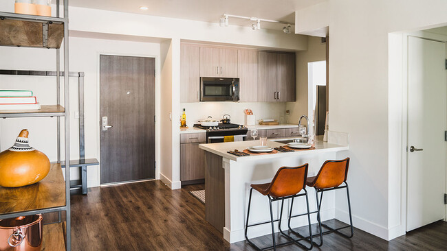 Chef-inspired kitchens enhance your entertaining skills with Caesarstone® quartz countertops, tile backsplashes and under-cabinet task lighting - Axis