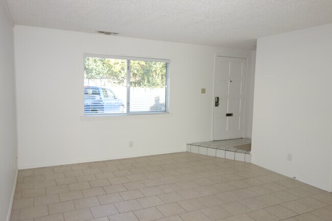 In the Living room facing East, Front window and door visible. Mail Slot on door! - 3451 E 35th St