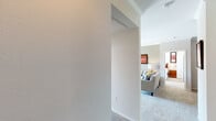 This single-floor residence offers a thoughtfully designed layout that balances comfort and functionality. The living room serves as the heart of the home, featuring plush carpeting, crown molding, a ceiling fan, and a classic white fireplace flanked by a sliding glass door that opens onto a private balcony with outdoor views of palm trees. Natural light fills the space, creating a bright and welcoming ambiance.

Adjacent to the living area, the dining room provides a dedicated space for meals, accented by crown molding and an open pass-through connection to the kitchen. The kitchen is well-equipped with light wood cabinetry extending to the ceiling, dark countertops, wood-look flooring, and a full suite of white appliances including a refrigerator, electric range, microwave, and dishwasher.

The residence includes two carpeted bedrooms, each featuring ceiling fans and large windows that invite natural light. Both rooms offer a calm, restful atmosphere with ample space. The full bathroom is finished with wood-look flooring, a white vanity, and a shower-tub combination with a window above for added brightness.

Throughout the home, consistent finishes such as crown molding, neutral tones, and textured walls contribute to a cohesive and comfortable living environment.
