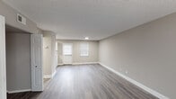Located at 2096 E Main St in Spartanburg, South Carolina, this two-floor residence combines modern updates with a clean, neutral aesthetic throughout. The main level welcomes visitors with a spacious living area finished in durable wood-look flooring and warm greige tones, complemented by white trim and natural light from window treatments. The kitchen stands out as a highlight, featuring white shaker cabinetry, granite-look countertops, a classic subway tile backsplash, stainless steel appliances, and a double sink — all designed for both functionality and style. A carpeted staircase leads to the upper level, where the bedrooms offer plush carpet flooring, ceiling fans, and ample natural light through blinds-fitted windows. At least one bedroom includes a closet with built-in shelving. The bathroom is well-appointed with a full tub-shower combination, a white vanity, and wood-look flooring that ties the space together cohesively. Textured ceilings are present throughout, and the consistent neutral color palette creates a calm, move-in-ready atmosphere. The layout flows intuitively between floors, making this a practical and comfortable space suitable for a variety of needs.