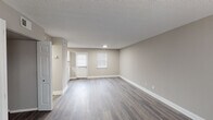 Located at 2096 E Main St in Spartanburg, South Carolina, this two-floor residence combines modern updates with a clean, neutral aesthetic throughout. The main level welcomes visitors with a spacious living area finished in durable wood-look flooring and warm greige tones, complemented by white trim and natural light from window treatments. The kitchen stands out as a highlight, featuring white shaker cabinetry, granite-look countertops, a classic subway tile backsplash, stainless steel appliances, and a double sink — all designed for both functionality and style. A carpeted staircase leads to the upper level, where the bedrooms offer plush carpet flooring, ceiling fans, and ample natural light through blinds-fitted windows. At least one bedroom includes a closet with built-in shelving. The bathroom is well-appointed with a full tub-shower combination, a white vanity, and wood-look flooring that ties the space together cohesively. Textured ceilings are present throughout, and the consistent neutral color palette creates a calm, move-in-ready atmosphere. The layout flows intuitively between floors, making this a practical and comfortable space suitable for a variety of needs.