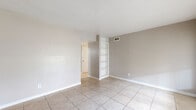 Located at 5500 El Camino del Rey St in Houston, TX, this single-story 2-bedroom, 3-bathroom home offers a well-organized layout designed for practical, comfortable living. Light-toned tile flooring runs consistently throughout the home, creating a clean and cohesive look across all main living areas.

The living room is a bright, open space featuring a distinctive built-in open shelving unit that adds both function and character. A hallway connects the main living areas to the bedrooms, providing a clear and efficient flow throughout the home. The dining room sits adjacent to the kitchen, offering a convenient space for meals.

The galley-style kitchen is thoughtfully designed with dark cabinetry lining both sides, providing ample storage. White appliances — including a range, oven, dishwasher, and refrigerator — complement the light countertops, while a stainless steel sink adds a practical touch.

The spacious primary bedroom includes its own closet and an en-suite bathroom featuring a wide vanity with a speckled countertop and dark cabinetry below a large mirror. The second bedroom is a comfortable size with a window that allows natural light. Four closets throughout the home ensure generous storage capacity. A pantry, an outdoor patio, and ceiling fans in key rooms round out this well-appointed Houston residence.