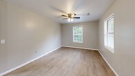 Located at 110 Biesecker Road in Lexington, North Carolina, this single-floor, 2-bedroom, 2-bathroom unit offers a functional and comfortable layout. The open-concept kitchen and living area serves as the heart of the home, featuring light wood-style laminate flooring that extends throughout the main living spaces. The kitchen is well-equipped with white cabinetry, dark granite-style countertops, a stainless steel double-basin sink, a dishwasher, electric range, and refrigerator, complemented by a window that brings in natural light and outdoor views. A pendant light adds a subtle decorative touch overhead. Both bedrooms are carpeted and include ceiling fans for year-round comfort. The primary bedroom is a well-proportioned space with two closets and windows offering natural light. The second bedroom also features a ceiling fan and a window with outdoor greenery views. The two bathrooms are clean and functional — one includes a vanity with a dark espresso cabinet, granite-topped sink, and modern fixtures, while the other features a tub-shower combo. A connecting hallway ties the layout together efficiently, making this a well-organized and move-in ready home.