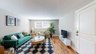 Located at 459 Kennard Rd in Manchester, New Hampshire, this single-floor residence offers a thoughtfully designed layout with consistent warm hardwood flooring flowing throughout the entire space, creating a cohesive and inviting atmosphere.

The living room is a comfortable and well-lit area, featuring natural light from a front-facing window. The open feel of the room is well-suited for both relaxing and entertaining.

The kitchen is efficiently designed with crisp white shaker-style cabinetry, granite countertops, a white subway tile backsplash, and a full suite of stainless steel appliances including a refrigerator, stove, microwave, and dishwasher. A window above the sink brings in natural light, and the space includes room for a small dining table.

The residence features two bedrooms, each finished with the same warm hardwood floors and neutral wall tones. Both rooms include closets with paneled doors and offer a calm, restful environment. One bedroom provides a particularly spacious feel with a large closet.

The bathroom is cleanly appointed with granite countertops, white cabinetry, subway tile, and a window that allows natural light to brighten the space. Dark tile flooring adds a grounding contrast to the lighter finishes throughout.