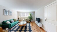 Located at 459 Kennard Rd in Manchester, New Hampshire, this single-floor residence offers a thoughtfully designed layout with consistent warm hardwood flooring flowing throughout the entire space, creating a cohesive and inviting atmosphere.

The living room is a comfortable and well-lit area, featuring natural light from a front-facing window. The open feel of the room is well-suited for both relaxing and entertaining.

The kitchen is efficiently designed with crisp white shaker-style cabinetry, granite countertops, a white subway tile backsplash, and a full suite of stainless steel appliances including a refrigerator, stove, microwave, and dishwasher. A window above the sink brings in natural light, and the space includes room for a small dining table.

The residence features two bedrooms, each finished with the same warm hardwood floors and neutral wall tones. Both rooms include closets with paneled doors and offer a calm, restful environment. One bedroom provides a particularly spacious feel with a large closet.

The bathroom is cleanly appointed with granite countertops, white cabinetry, subway tile, and a window that allows natural light to brighten the space. Dark tile flooring adds a grounding contrast to the lighter finishes throughout.