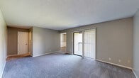 Located at 8 N Keene St in Columbia, Missouri, this single-floor, 3-bedroom, 1-bathroom home offers a practical and comfortable layout across a well-utilized footprint. The open living area is finished with plush carpet and features a sliding glass door with vertical blinds that leads to a private balcony with outdoor views, bringing in natural light and a sense of openness. The textured ceilings are consistent throughout the home, lending a classic residential feel.

The galley-style kitchen is efficiently designed with white cabinetry, granite-patterned countertops, a double-basin sink, and white appliances including a range and refrigerator. Wood-style flooring grounds the kitchen and connects seamlessly to the rest of the home's common areas.

Three bedrooms provide flexible living arrangements. The primary bedroom offers generous square footage with plush carpeting. The additional bedrooms each feature ceiling fans with light fixtures, carpeted or wood-style flooring, closet storage, and windows with blinds that allow for natural light. Neutral gray-toned walls throughout create a clean, cohesive aesthetic.

The bathroom includes a full tub-shower combo, toilet, and vanity with a mirror, finished in neutral tones. Multiple hallways and two entrance points enhance the flow and accessibility of the home's layout.