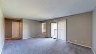 Located at 8 N Keene St in Columbia, Missouri, this single-floor, 3-bedroom, 1-bathroom home offers a practical and comfortable layout across a well-utilized footprint. The open living area is finished with plush carpet and features a sliding glass door with vertical blinds that leads to a private balcony with outdoor views, bringing in natural light and a sense of openness. The textured ceilings are consistent throughout the home, lending a classic residential feel.

The galley-style kitchen is efficiently designed with white cabinetry, granite-patterned countertops, a double-basin sink, and white appliances including a range and refrigerator. Wood-style flooring grounds the kitchen and connects seamlessly to the rest of the home's common areas.

Three bedrooms provide flexible living arrangements. The primary bedroom offers generous square footage with plush carpeting. The additional bedrooms each feature ceiling fans with light fixtures, carpeted or wood-style flooring, closet storage, and windows with blinds that allow for natural light. Neutral gray-toned walls throughout create a clean, cohesive aesthetic.

The bathroom includes a full tub-shower combo, toilet, and vanity with a mirror, finished in neutral tones. Multiple hallways and two entrance points enhance the flow and accessibility of the home's layout.