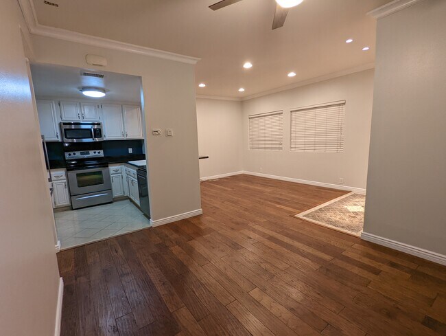 View of kitchen and living room from dining room area - 730 W 4th St