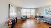 Located at 105 N Willow St in Liverpool, NY, this single-floor, 2-bedroom, 1-bathroom residence offers a practical and comfortable layout with well-maintained finishes throughout. The living room serves as the heart of the home, showcasing warm hardwood flooring, large windows that invite generous natural light, and a neutral color palette that creates a bright and welcoming atmosphere. The updated kitchen is equipped with stainless steel appliances — including a range, microwave, and dishwasher — complemented by gray cabinetry, marble-style countertops, and a slate-tiled backsplash. Light-toned vinyl flooring and a window overlooking the exterior give the kitchen a clean, airy feel. A dedicated dining area adjacent to the kitchen provides space for everyday meals. Both bedrooms continue the hardwood flooring and feature ceiling fans, baseboard heating, and natural light from windows. The primary bedroom includes a closet, and the second bedroom also offers closet storage. Four closets total are distributed throughout the home. The full bathroom features a tub/shower combination and a window for natural ventilation. Baseboard heating is present throughout the residence.