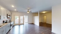 Located at 4913 Whetsel Ave in Cincinnati, Ohio, this single-floor residence offers a thoughtfully designed open-concept layout that seamlessly connects the kitchen, dining, and living areas. Rich, dark hardwood-style flooring runs throughout the main living space, complemented by recessed lighting and a ceiling fan that add both function and style.

The kitchen is a standout feature, showcasing soft gray shaker-style cabinetry, granite countertops, a classic white subway tile backsplash, and a full suite of stainless steel appliances, including a refrigerator, range, microwave, and dishwasher. The layout provides generous counter space and ample storage for everyday living.

The open living area is bright and airy, with natural light streaming through a set of elegant French doors that lead directly to a private balcony, offering an inviting indoor-outdoor connection. The space also includes an in-unit laundry area, providing added convenience.

The bathroom is finished with consistent gray cabinetry, granite countertops, a vanity mirror, and a stand-up shower. A spacious walk-in closet with wire shelving offers excellent storage. The overall design palette—neutral tones, modern finishes, and clean lines—creates a cohesive and contemporary living environment.