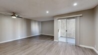 Located at 331 S Sunrise Way in Palm Springs, California, this efficiently designed single-floor unit offers a thoughtfully arranged layout comprising a living room, kitchen, bathroom, and hallway. The space is finished with wood-look luxury vinyl plank flooring that runs consistently throughout, complemented by neutral gray wall tones and clean white baseboards that lend a cohesive, modern aesthetic.

The living area is an open, airy space featuring recessed lighting, a textured ceiling, and a ceiling fan for comfort in the desert climate. A sliding glass door leads to an outdoor area, allowing natural light to fill the room and providing easy access to the exterior.

The galley-style kitchen is well-equipped with stainless steel appliances, including a range, microwave, refrigerator, and dishwasher. White shaker cabinetry with brushed nickel hardware lines both sides of the kitchen, paired with gray countertops and a double stainless steel sink — creating a clean, functional workspace.

The bathroom continues the same refined palette, featuring white cabinetry, gray countertops, brushed nickel fixtures, and matching vinyl flooring. The hallway connects the living spaces efficiently, with a mirrored closet adding visual depth. Recessed lighting throughout the unit ensures a bright, welcoming atmosphere.
