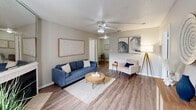 This well-appointed 2-bedroom, 2-bathroom single-story home in Lafayette, Louisiana offers a functional and comfortable layout. The living room serves as the heart of the home, featuring wood-look flooring, a ceiling fan, and a classic fireplace with a tiled surround and mirrored mantle, adding depth and character to the space. Natural light filters in through the front window, creating a warm and welcoming ambiance. The open flow connects the living area to a dedicated dining space. The galley-style kitchen is efficiently designed with warm honey-toned wood cabinetry, granite-look countertops, black appliances including an electric range and dishwasher, and a stainless steel refrigerator. A pantry and direct access to a utility room with in-unit laundry add everyday convenience. The spacious primary bedroom accommodates a full suite of furniture and includes a ceiling fan, a window for natural light, and ample closet storage. The second bedroom is similarly well-sized with matching flooring and a ceiling fan. Both bathrooms are consistently finished with oak-toned vanities, overhead lighting, wall-mounted storage cabinets, and shower/tub combinations. Wood-look flooring runs throughout the home, tying each room together with a cohesive, clean aesthetic.