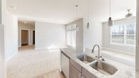 This contemporary residence in Charlotte, NC offers a harmonious blend of space and comfort across two floors. The home's 1470 square feet are thoughtfully distributed, with 300 sq ft on the ground floor and 1180 sq ft on the upper level. The crown jewel is the expansive 950 sq ft primary bedroom, providing ample space for relaxation and privacy.

Throughout the home, large windows with white blinds allow natural light to flood the rooms, creating a bright and airy atmosphere. The neutral color palette, featuring soft beige walls and plush carpeting in most areas, offers a versatile backdrop for various decor styles.

The kitchen boasts modern amenities, including stainless steel appliances, granite countertops, and pendant lighting. It opens to a living area, ideal for entertaining. Hardwood flooring in select areas adds warmth and sophistication to the space.

Both bedrooms are generously sized, with the second bedroom featuring a ceiling fan for added comfort. The inclusion of a balcony provides an outdoor retreat, perfect for enjoying morning coffee or evening relaxation.

The property's layout, as seen in the floor plan image, reveals a well-designed space that maximizes functionality. With its combination of spacious rooms, modern finishes, and thoughtful design, this home offers a comfortable and stylish living experience in a desirable Charlotte location.