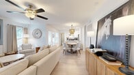 Located in Bedford, TX, this well-appointed 2-bedroom, 2-bathroom single-floor residence offers a thoughtfully designed open-concept layout that seamlessly connects the living, dining, and kitchen areas. Light wood-look flooring flows throughout the main living spaces, complemented by crisp white walls and an abundance of natural light, creating a bright and airy atmosphere. The living room features a ceiling fan and built-in shelving, providing both comfort and functional display space. The kitchen is a standout, outfitted with white shaker cabinetry, granite countertops, stainless steel appliances, and a peninsula with bar seating — ideal for casual dining. A dedicated pantry adds to the kitchen's practicality. The primary bedroom is generously sized, complete with a ceiling fan and ample closet space. The second bedroom is bright and comfortable, featuring a ceiling fan and a large window with outdoor views. Both bathrooms are finished with floor-to-ceiling marble-look tile — one with a walk-in shower with brushed gold fixtures, and the other with a tub-shower combination. A private balcony extends the living space outdoors. With six closets throughout, storage is plentiful. The unit also includes a hallway connecting the key areas for a cohesive and functional flow.
