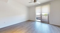 This contemporary 520 square foot apartment in Carson, California, offers a thoughtfully designed living space. The heart of the home is an open-concept kitchen and living area, showcasing a sleek, modern aesthetic. The kitchen boasts white cabinetry, stainless steel appliances, and a subway tile backsplash, creating a clean and efficient cooking space. Light wood flooring flows throughout, adding warmth and continuity to the entire apartment.

The living area is bright and airy, with large windows and access to one of the two balconies, allowing for abundant natural light and outdoor views. A ceiling fan ensures comfortable air circulation. The bathroom features a modern vanity, large mirror, and a combination shower/tub, maintaining the apartment's stylish design. A dedicated closet space provides ample storage with built-in shelving.

Track lighting in the kitchen and living areas offers adjustable illumination, while recessed lighting in other spaces maintains a clean ceiling line. The apartment's layout maximizes the use of space, creating a comfortable and functional living environment within its compact 520 square feet. With its modern finishes and thoughtful design, this apartment presents an attractive option for urban living in Carson.