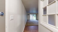 Located in Palos Hills, IL, this one-bedroom, one-bathroom residence offers a practical and well-organized single-floor layout. The living room features a combination of warm hardwood-style flooring and plush carpet, creating a comfortable and versatile space. Neutral white walls and baseboard heating run throughout, contributing to a clean, consistent aesthetic. A window in the living area allows natural light to filter in, enhancing the open feel of the space.

The galley-style kitchen is thoughtfully designed with gray shaker cabinets, white countertops, and stainless steel appliances, including a refrigerator, gas range, and dishwasher. A stainless steel sink with a modern faucet completes the functional workspace, while light wood-look flooring ties the room together.

The bedroom is a well-sized, carpeted retreat featuring a window with views of the surrounding greenery, providing a quiet and restful atmosphere. Baseboard heating ensures year-round comfort.

The bathroom is finished with a gray vanity with white countertop, a framed mirror, brushed nickel fixtures, and a tiled tub/shower combination. Wood-look flooring and soft gray wall tones give the bathroom a cohesive, updated look. Overall, this residence offers a clean, move-in-ready environment in a convenient Palos Hills location.