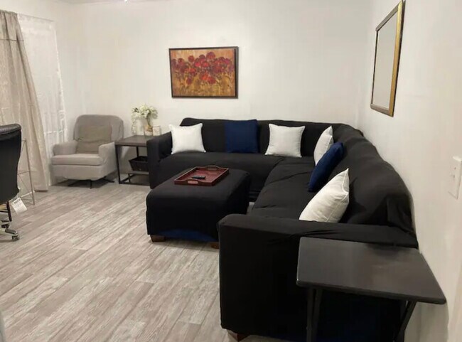 Living room with large sectional and smart TV and desk area - 805 Briarwood Rd