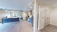 Located at 1464 E 105th St in Cleveland, Ohio, this modern 2-bedroom, 1-bathroom unit offers a well-designed, open-concept layout with contemporary finishes throughout. Light-toned hardwood-style flooring flows seamlessly across the entire space, complementing the clean, neutral color palette.

The kitchen is a standout feature, equipped with a full suite of stainless steel appliances including a range, microwave, dishwasher, and refrigerator. Two-tone cabinetry — pairing blue-grey lower cabinets with light upper cabinets — surrounds a subway tile backsplash and granite-style countertops. A kitchen island with additional storage adds both workspace and visual appeal. Recessed lighting illuminates the area, which opens directly into the living space.

The living room is bright and inviting, anchored by a large picture window that frames views of the surrounding neighborhood and fills the room with natural light.

The bedrooms are comfortably sized, with the primary bedroom featuring exposed ductwork that adds an industrial character. A walk-in closet with built-in wire shelving provides generous storage.

The bathroom is clean and modern, featuring a wide vanity with an undermount sink, warm wood-toned cabinetry, and a large mirror with bright overhead lighting. Tile flooring completes the space. The unit's efficient layout maximizes every square foot for comfortable everyday living.
