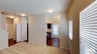 This two-floor residence offers a functional and well-organized layout with a neutral color palette throughout. The kitchen serves as a standout feature, showcasing dark espresso cabinetry, granite-style countertops, stainless steel appliances including a dishwasher, gas range, refrigerator, and built-in microwave, along with rich hardwood flooring and access to a exterior door that brings in generous natural light.

The living areas transition from hardwood to plush carpeted flooring, providing a comfortable feel across the space. Bedrooms are generously sized, each benefiting from large windows that allow ample natural light. The primary bedroom includes both a walk-in closet with built-in shelving and a dedicated en-suite bathroom featuring a sliding glass walk-in shower, a dark-toned vanity, and a window for ventilation. A secondary full bathroom offers a shower-tub combination with clean white tile surround and a matching dark vanity.

Additional highlights include a dedicated laundry room equipped with a full-size washer and dryer, adding everyday convenience. The space maintains a clean, move-in-ready aesthetic with consistent warm-toned walls and white trim throughout.