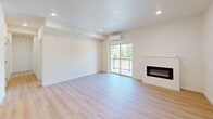 This well-appointed 2-bedroom, 2-bathroom apartment in Vancouver, WA offers a thoughtfully designed single-level layout with modern finishes throughout. Light-toned luxury vinyl plank flooring flows seamlessly across the entire unit, creating a cohesive and contemporary aesthetic.

The open-concept kitchen and living area serves as the heart of the home. The kitchen features two-tone cabinetry — light wood uppers paired with charcoal lower cabinets — accented by white quartz countertops, a subway tile backsplash, stainless steel appliances, and a central island ideal for dining or meal prep. The adjoining living room is bright and spacious, anchored by a sleek built-in electric fireplace and a sliding glass door that opens to a private balcony overlooking lush, mature greenery. A wall-mounted mini-split system provides efficient climate control.

Both bedrooms are bright and comfortable, each featuring windows with verdant outdoor views and a wall-mounted mini-split unit. The primary bedroom includes a sliding double-door closet for ample storage. The two bathrooms are clean and modern, each outfitted with a full soaking tub, shower combination, white tile surrounds, brushed nickel fixtures, and contemporary vanities with white countertops.