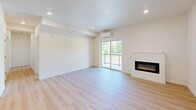 This well-appointed 2-bedroom, 2-bathroom apartment in Vancouver, WA offers a thoughtfully designed single-level layout with modern finishes throughout. Light-toned luxury vinyl plank flooring flows seamlessly across the entire unit, creating a cohesive and contemporary aesthetic.

The open-concept kitchen and living area serves as the heart of the home. The kitchen features two-tone cabinetry — light wood uppers paired with charcoal lower cabinets — accented by white quartz countertops, a subway tile backsplash, stainless steel appliances, and a central island ideal for dining or meal prep. The adjoining living room is bright and spacious, anchored by a sleek built-in electric fireplace and a sliding glass door that opens to a private balcony overlooking lush, mature greenery. A wall-mounted mini-split system provides efficient climate control.

Both bedrooms are bright and comfortable, each featuring windows with verdant outdoor views and a wall-mounted mini-split unit. The primary bedroom includes a sliding double-door closet for ample storage. The two bathrooms are clean and modern, each outfitted with a full soaking tub, shower combination, white tile surrounds, brushed nickel fixtures, and contemporary vanities with white countertops.