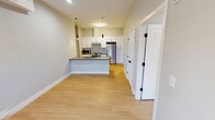 This 520 square foot apartment offers a thoughtful blend of efficiency and comfort. The single-floor layout comprises one bedroom, one bathroom, a kitchen, and a hallway, creating a well-organized living space. The modern kitchen is a standout feature, boasting white cabinetry, stainless steel appliances, and a sleek subway tile backsplash. A central island with a sink provides additional prep space and separates the kitchen from the living area. The bedroom, measuring 100 square feet, features hardwood flooring and neutral walls, offering a tranquil retreat. The bathroom is designed with a contemporary aesthetic, featuring a white color scheme, a vanity with under-sink storage, and a combination bathtub-shower. Throughout the apartment, recessed lighting and pendant fixtures provide ample illumination. The use of light colors and hardwood flooring throughout creates a sense of continuity and spaciousness. Climate control is ensured by a wall-mounted air conditioning unit, adding to the overall comfort of this compact yet functional living space.