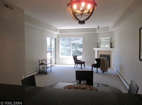 Open living/dining with fireplace - 7540 Edinborough Way