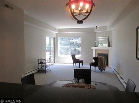 Open living/dining with fireplace - 7540 Edinborough Way