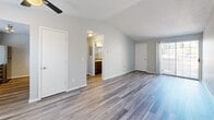 Located at 295 3rd St in Lake Oswego, Oregon, this single-floor, one-bedroom unit offers a thoughtfully designed layout that makes efficient use of its space. Throughout the unit, wood-style luxury vinyl plank flooring provides a clean, contemporary look that ties each room together seamlessly.

The living room is bright and open, featuring vaulted ceilings with a ceiling fan, soft neutral walls, and a sliding glass door that leads to a private patio and fills the room with natural light. Adjacent to the living area, the galley-style kitchen is well-equipped with rich dark cabinetry, light countertops, stainless steel appliances including a refrigerator, electric range, built-in microwave, and dishwasher, as well as a window above the sink for added brightness.

The spacious primary bedroom accommodates comfortable living with two mirrored sliding-door closets and a large window that brings in natural light. The bathroom features a full tub and shower combination with a curved rod, grab bars, and a small window for ventilation. A dedicated laundry area and a connecting hallway complete the functional layout. The unit also benefits from ample closet storage, making it a practical and comfortable home in the heart of Lake Oswego.