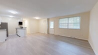 Located at 6502 McClean Blvd in Baltimore, MD, this single-floor, 2-bedroom, 1-bathroom home offers a clean, modern aesthetic with a bright and welcoming atmosphere. Light-toned wood-style flooring flows throughout the entire unit, complementing the warm cream-colored walls and crisp white trim.

The open-concept living area is generously sized, featuring multiple windows with blinds that allow ample natural light and a direct exterior door providing easy outdoor access. The kitchen is thoughtfully designed with white shaker-style cabinetry, granite-look countertops, stainless steel appliances including a refrigerator, dishwasher, electric range, and over-the-range microwave, plus a peninsula that separates it from the living space.

The primary bedroom is spacious, accommodating a variety of furniture arrangements, and includes a closet for storage. The second bedroom also benefits from natural light through a window with blinds. Throughout the home, four closets provide exceptional storage capacity.

The bathroom is neatly finished with tile flooring, a white vanity with under-cabinet storage, a mirror, and clean fixtures. The overall design of the home is fresh and move-in ready, making it a practical and comfortable residence in Baltimore's McClean neighborhood.