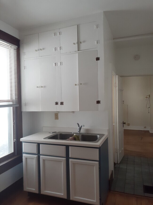 Kitchen with living/sleeping room in the background - 505 8th Ave SE