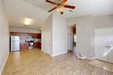 Located at 14001 Three Rivers Rd in Gulfport, Mississippi, this single-story 2-bedroom, 2-bathroom home offers a comfortable and efficiently designed living space. The open-concept living and dining area immediately impresses with vaulted ceilings and a ceiling fan, creating an airy, spacious feel. Light wood-look flooring flows consistently throughout the main living areas, lending warmth and cohesion to the interior.

The kitchen is well-equipped, featuring rich wooden cabinetry, granite-look countertops, and a full suite of stainless steel appliances including a refrigerator, range, microwave, and dishwasher. It connects seamlessly to the dining area, making the space ideal for everyday living and entertaining.

Both bedrooms are generously proportioned, each with ceiling fans and ample natural light from windows fitted with blinds. The primary bedroom offers notable space, while both rooms benefit from abundant closet storage — a standout feature with seven closets throughout the home. The two bathrooms are finished with tile flooring and include shower areas. An in-unit laundry area adds further convenience. A dedicated entrance, hallway, and thoughtful layout complete this functional and comfortable home.